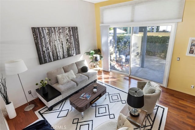 living room with a wealth of natural light and hardwood / wood-style floors