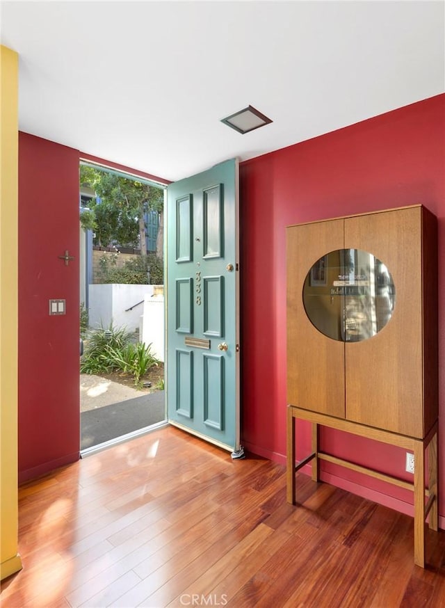 foyer featuring floor to ceiling windows and hardwood / wood-style floors