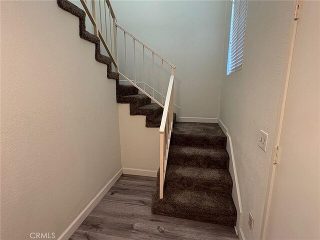 stairway featuring wood-type flooring