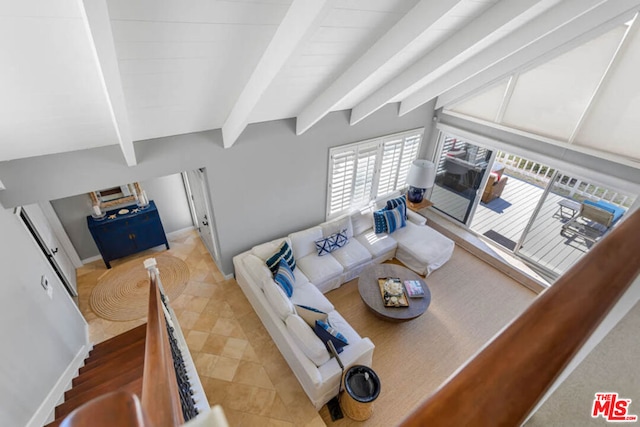 living room with lofted ceiling with beams