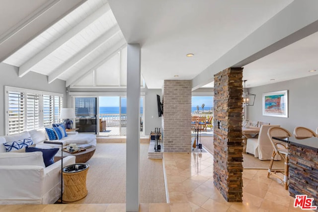 tiled living room featuring lofted ceiling with beams and decorative columns