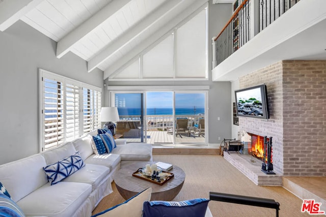 living room with a brick fireplace, beamed ceiling, high vaulted ceiling, and a water view