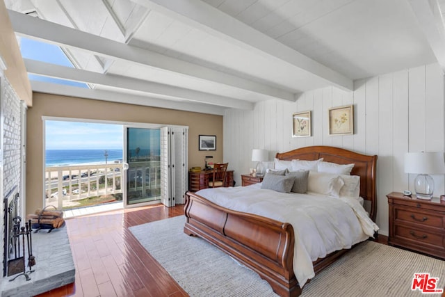 bedroom featuring beamed ceiling, access to outside, a water view, and light wood-type flooring