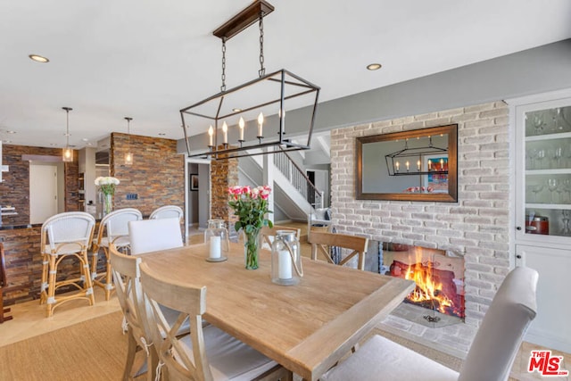 dining space featuring a multi sided fireplace and a chandelier