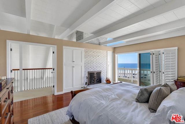 bedroom featuring a fireplace, hardwood / wood-style floors, access to outside, beamed ceiling, and a water view