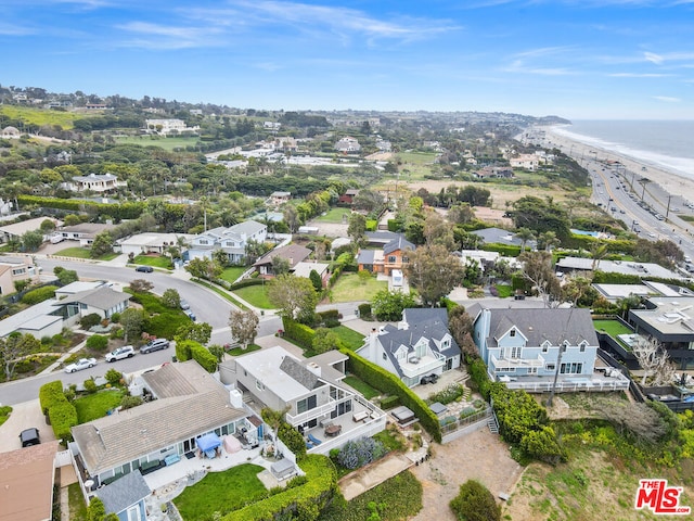 birds eye view of property with a view of the beach and a water view