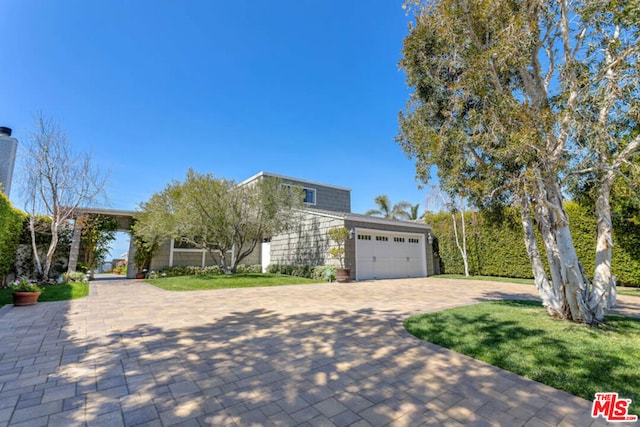 view of front facade with a front lawn and a garage