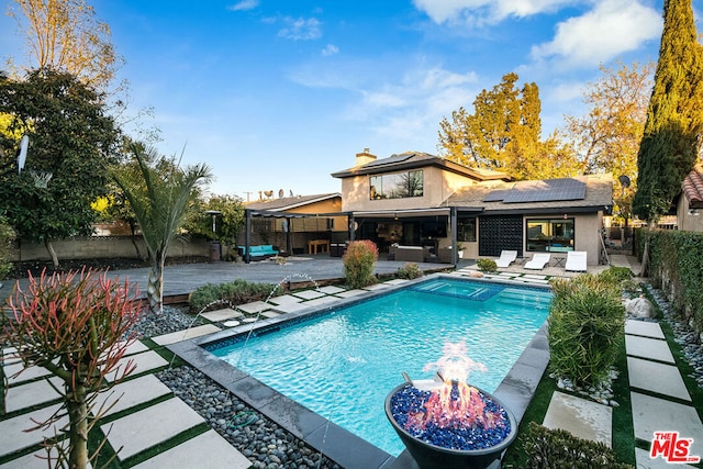 view of pool with a patio area and a fire pit