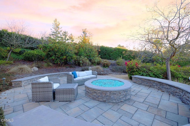 patio terrace at dusk with an outdoor fire pit