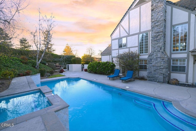 view of pool at dusk