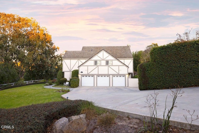 view of front facade with a garage and a lawn