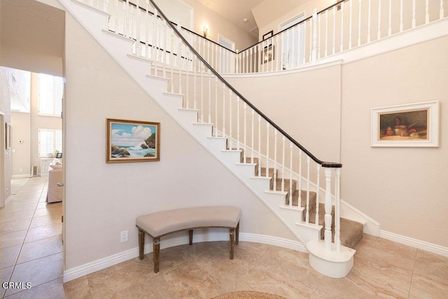 stairs featuring a towering ceiling