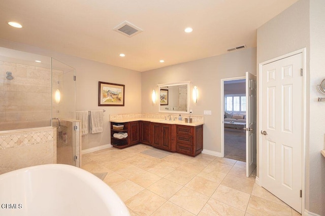 bathroom with separate shower and tub, vanity, and tile patterned flooring