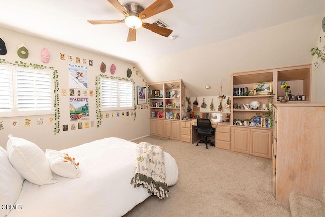 carpeted bedroom featuring ceiling fan, lofted ceiling, and built in desk