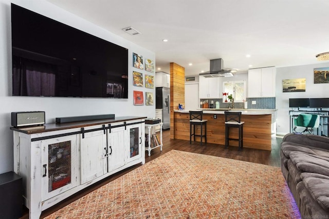 living room with dark hardwood / wood-style floors and wine cooler