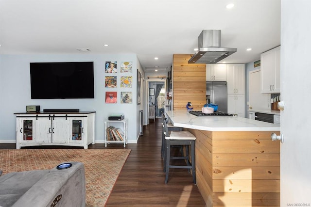 kitchen with a kitchen bar, white cabinetry, stainless steel fridge with ice dispenser, dark hardwood / wood-style floors, and island exhaust hood