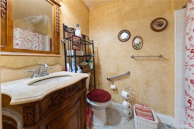 bathroom featuring tile patterned floors, toilet, vanity, and a shower with curtain