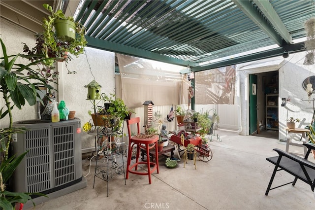 view of patio with cooling unit and a pergola