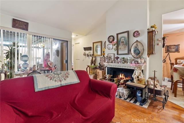 living room with wood-type flooring and vaulted ceiling