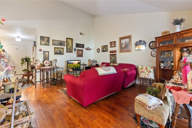 bedroom featuring vaulted ceiling and dark wood-type flooring