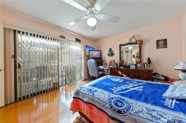 bedroom featuring ceiling fan, access to outside, and multiple windows