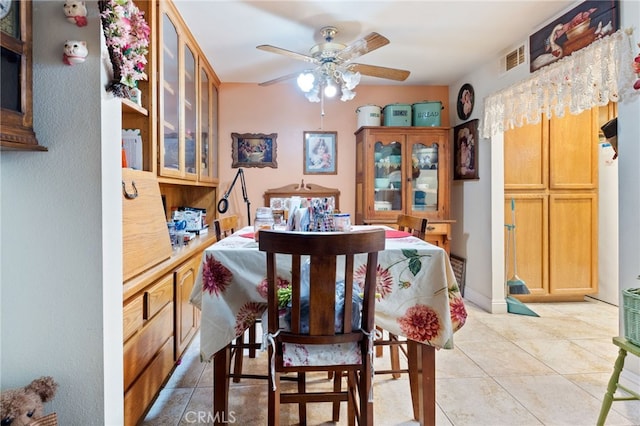 tiled dining room featuring ceiling fan