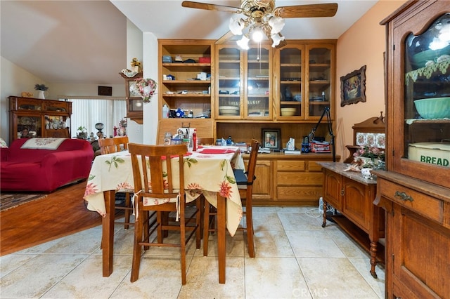 dining space with ceiling fan and light tile patterned flooring