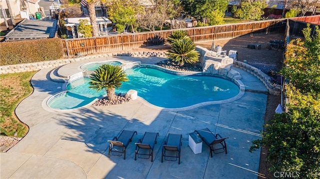 view of swimming pool featuring an in ground hot tub and a patio