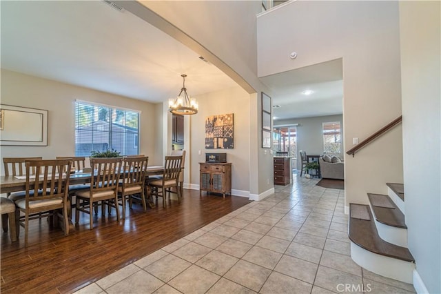 tiled dining space with a notable chandelier and plenty of natural light