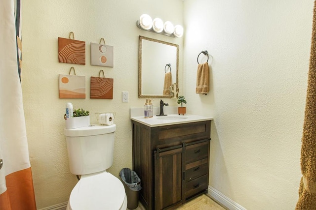 bathroom with toilet and vanity