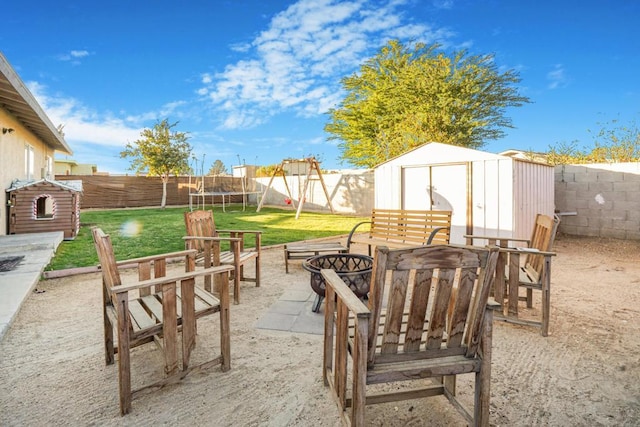 view of patio / terrace with a storage shed and a trampoline