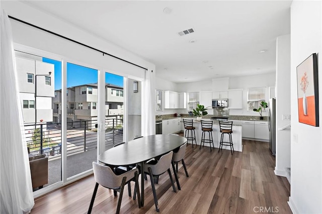 dining space featuring dark hardwood / wood-style floors