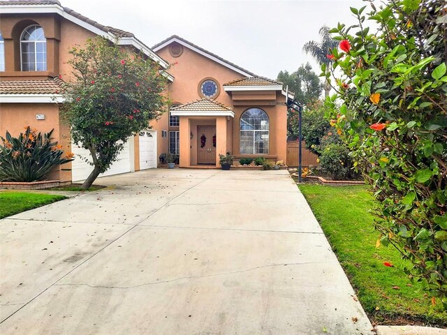 mediterranean / spanish home featuring a front yard