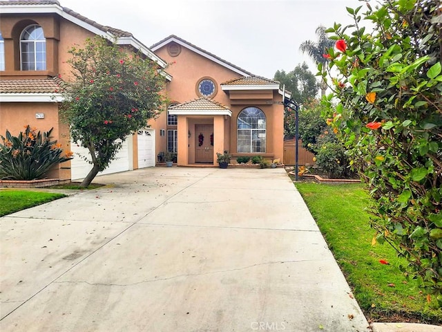 mediterranean / spanish-style home with a front yard