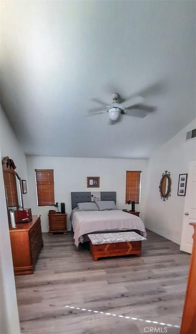 bedroom with ceiling fan and light wood-type flooring