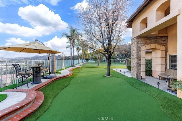 surrounding community with a water and mountain view and a patio