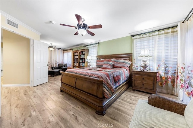 bedroom with ceiling fan, ornamental molding, and light hardwood / wood-style floors