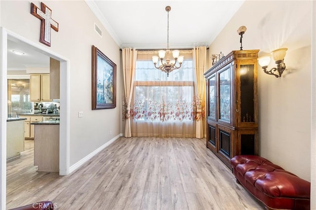 interior space featuring light hardwood / wood-style floors, crown molding, and a notable chandelier