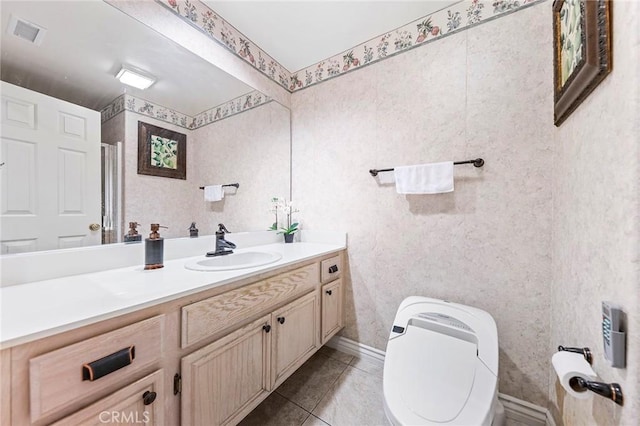 bathroom featuring toilet, tile patterned floors, and vanity