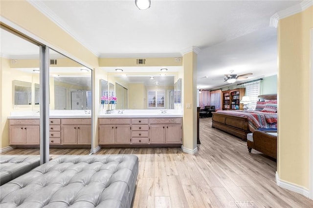 bathroom featuring hardwood / wood-style flooring, vanity, crown molding, and ceiling fan