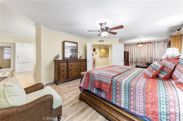 bedroom featuring light wood-type flooring, ceiling fan, and crown molding