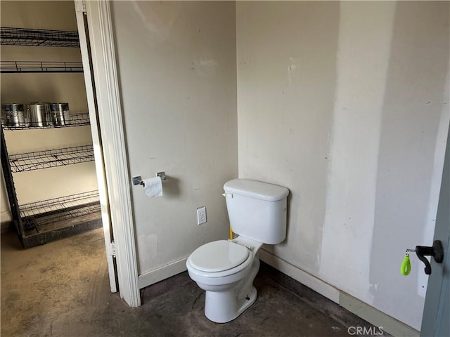 bathroom featuring toilet and concrete floors