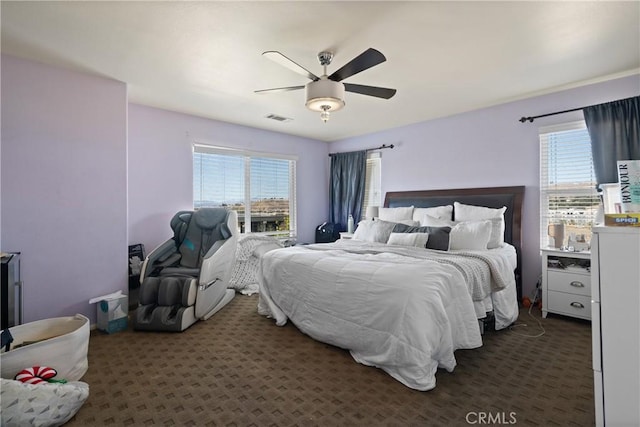 bedroom featuring ceiling fan and dark carpet