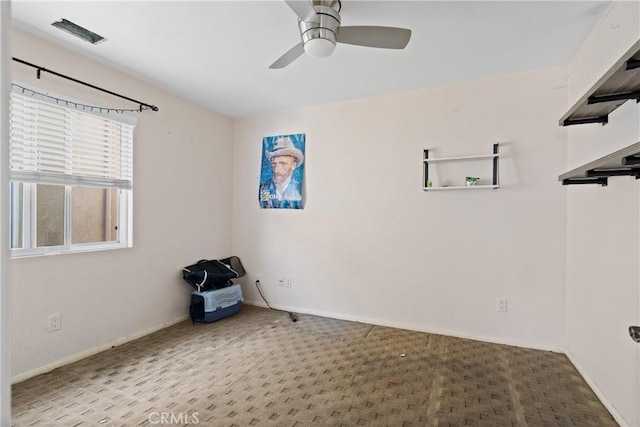 spare room with carpet and ceiling fan