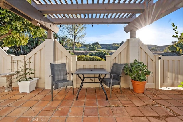 view of patio / terrace with a pergola and a mountain view