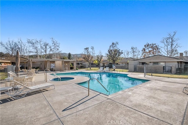 view of pool featuring a patio and a community hot tub