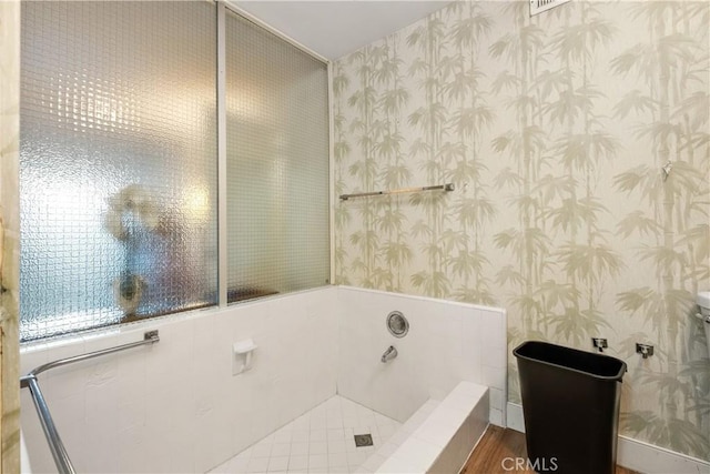 bathroom featuring a tub and hardwood / wood-style floors