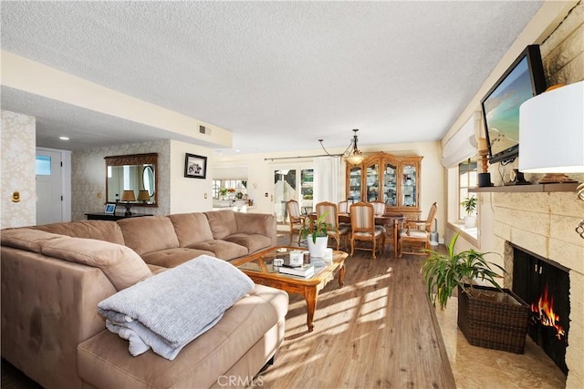 living room with wood-type flooring and a textured ceiling