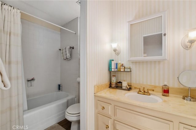 full bathroom featuring toilet, vanity, and shower / bath combination with curtain