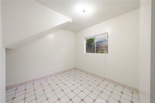 bonus room with a textured ceiling